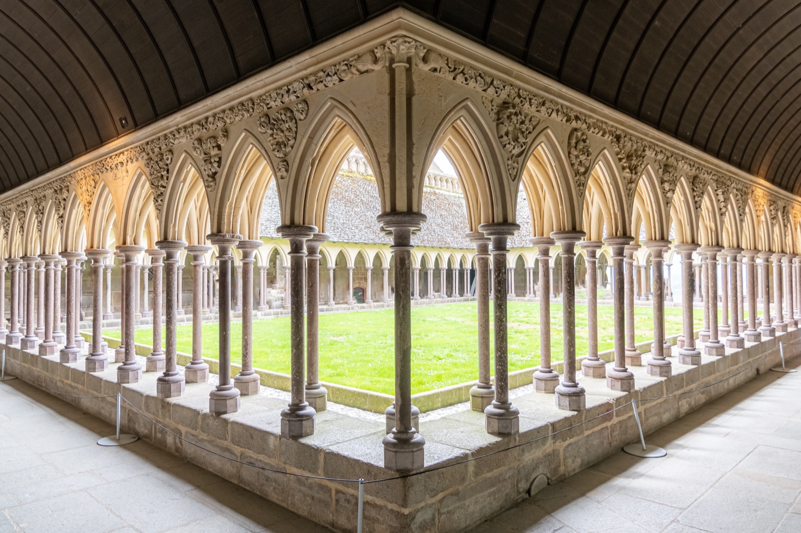 The arcaded cloister of Mont-Saint-Michel Abbey around a square of lawn